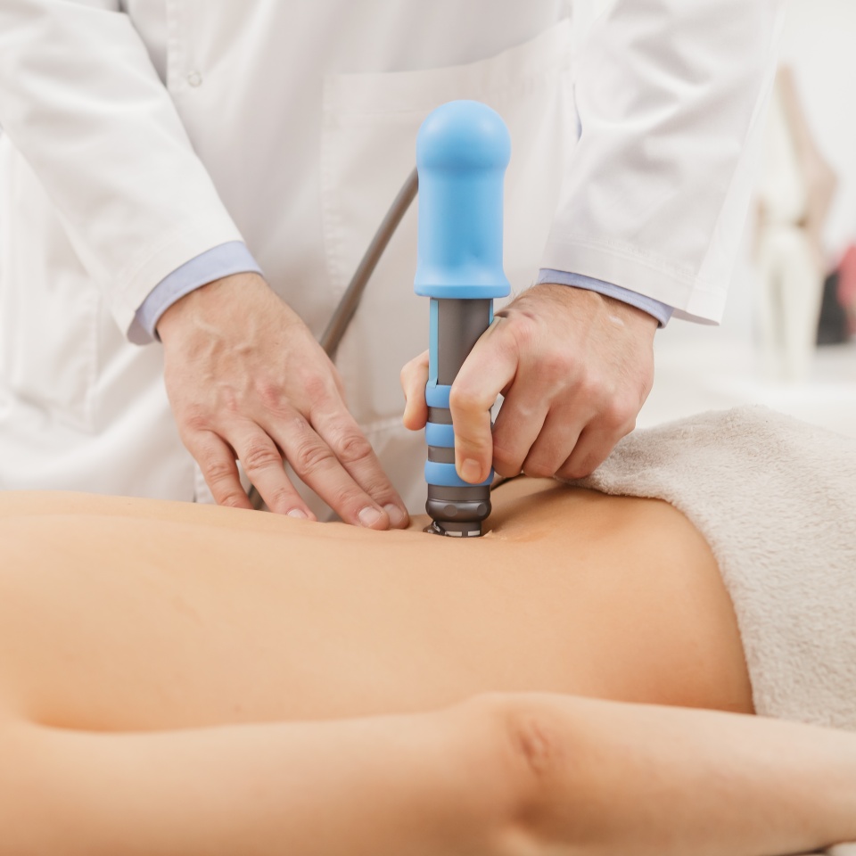 Extracorporeal Shockwave Therapy ESWT.Effective non-surgical treatment.Physical therapy for lower back with shock waves.Pain relief, normalization and regeneration,stimulation of healing process.