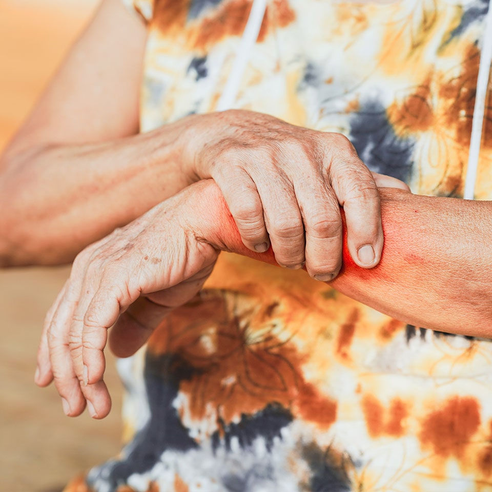 Senior woman holding his painful wrist.