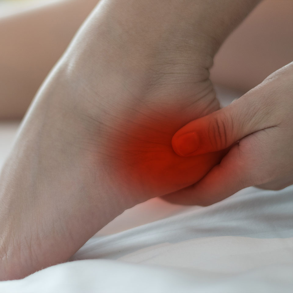 hand on foot as suffer from inflammation feet problem