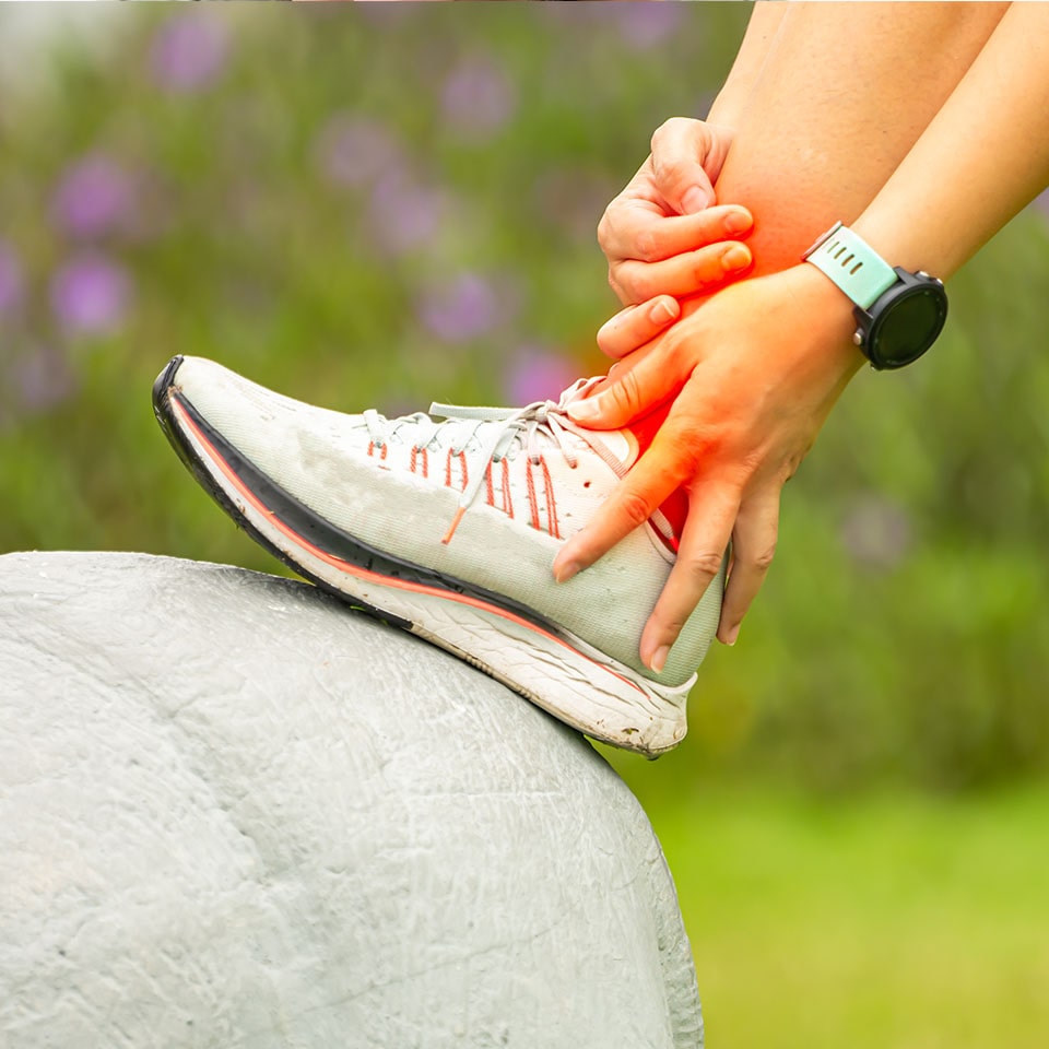 Sport woman has sore ankle from exercising training.