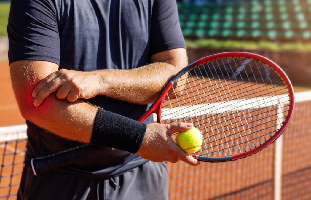 tennis elbow. male player with pain in his elbow joint. hand joint inflammation. sport injury. banner with copy space
