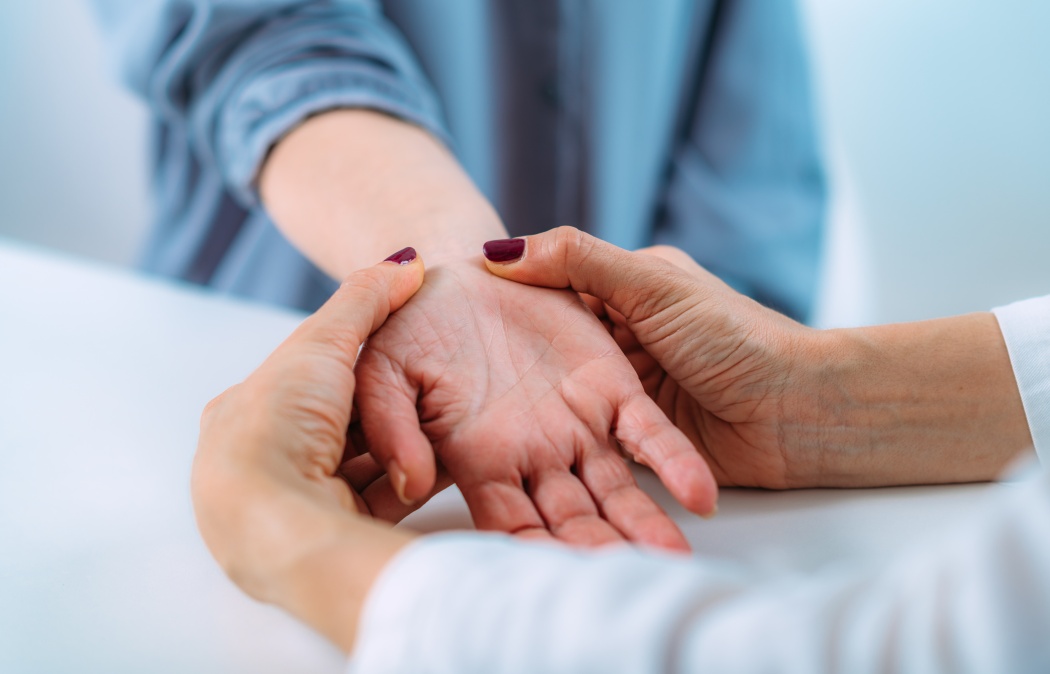 Examining the hand of a senior patient with carpal tunnel syndrome. Close-up image of senior woman’s wrist.